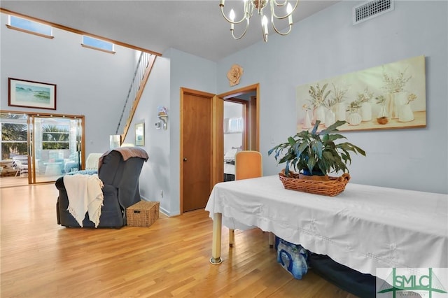 dining room with a chandelier and wood-type flooring