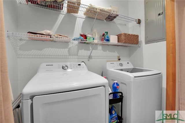 washroom featuring washing machine and clothes dryer and electric panel