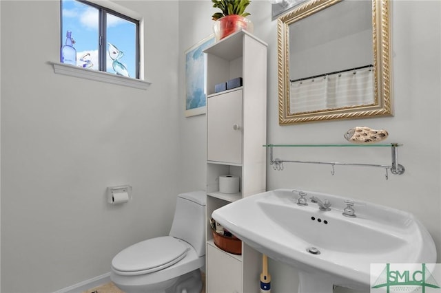 bathroom featuring toilet and sink