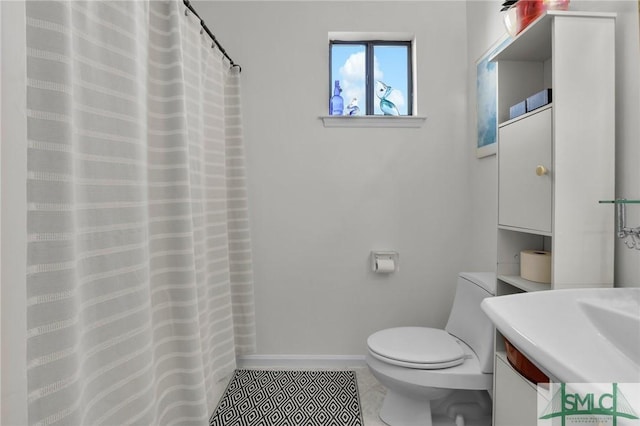 bathroom featuring tile patterned flooring, vanity, and toilet