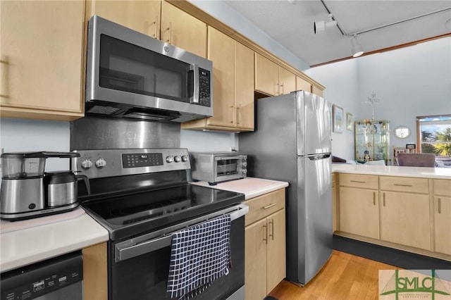 kitchen with light brown cabinetry, light hardwood / wood-style flooring, appliances with stainless steel finishes, and track lighting