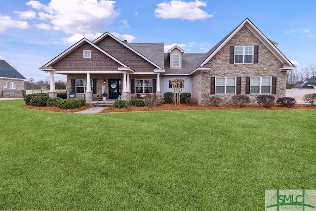 craftsman house with a front lawn and covered porch