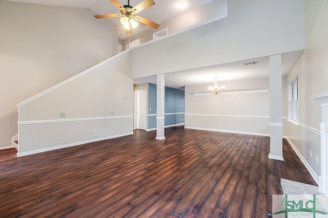 unfurnished living room featuring ceiling fan with notable chandelier, a high ceiling, and dark wood-type flooring