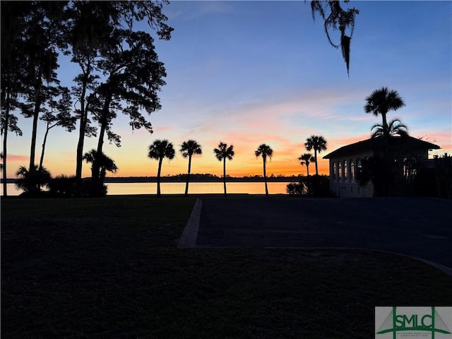 yard at dusk with a water view