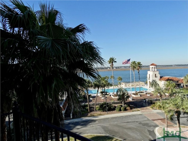 view of swimming pool featuring a water view