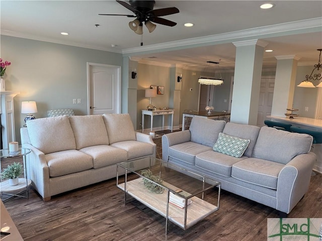 living room featuring crown molding, ceiling fan, dark hardwood / wood-style flooring, and decorative columns