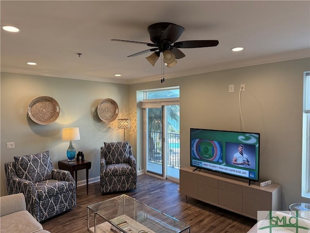 living room featuring crown molding, dark hardwood / wood-style floors, and ceiling fan