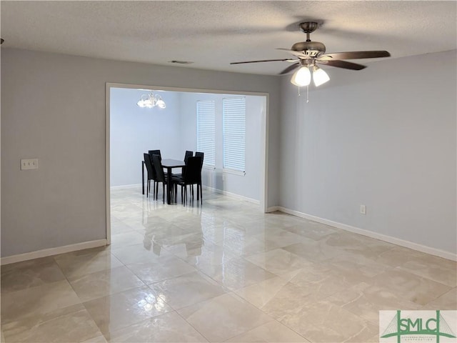 unfurnished dining area with a textured ceiling and ceiling fan with notable chandelier