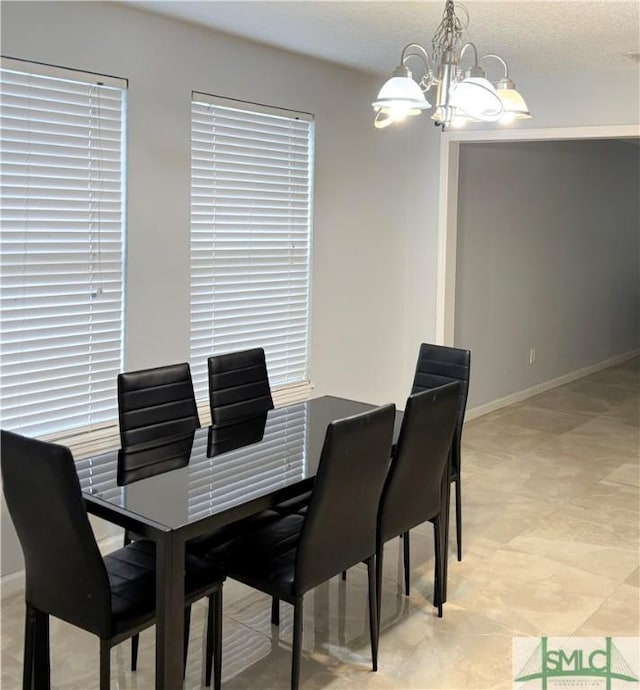 dining room with light tile patterned floors and a chandelier