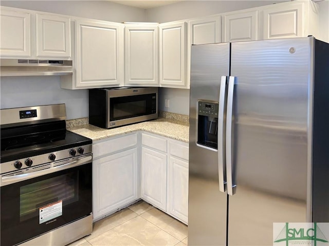 kitchen featuring white cabinetry, light tile patterned floors, and stainless steel appliances