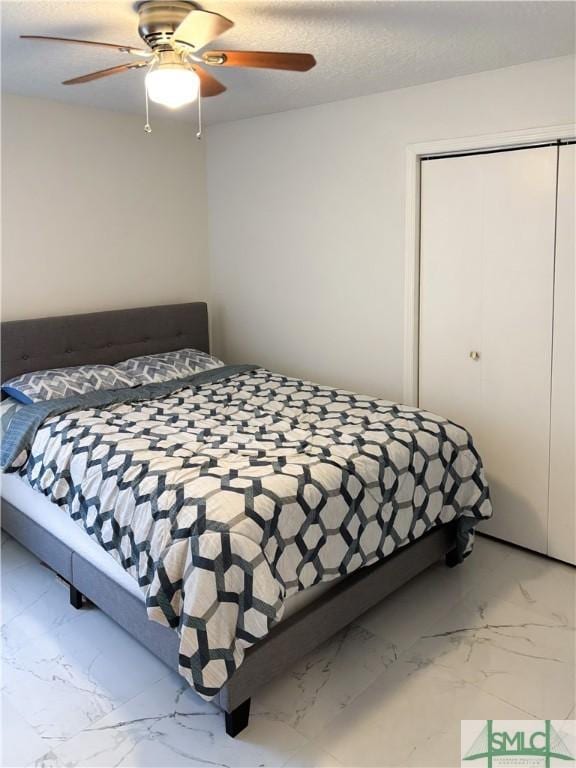 bedroom featuring ceiling fan and a closet