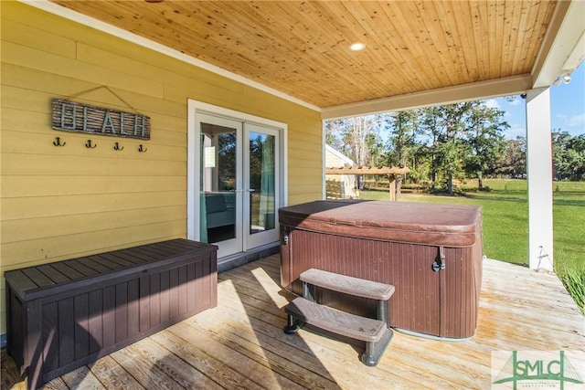 deck with french doors and a hot tub