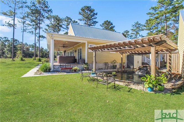 exterior space featuring a pergola, a patio, a yard, and a hot tub