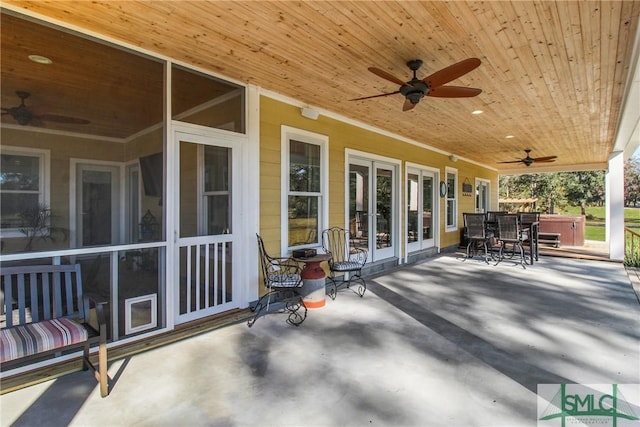 view of patio / terrace featuring ceiling fan and a hot tub