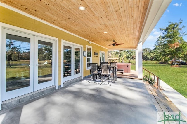 view of patio featuring french doors, a hot tub, and ceiling fan