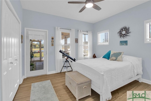 bedroom featuring ceiling fan, light wood-type flooring, and a closet