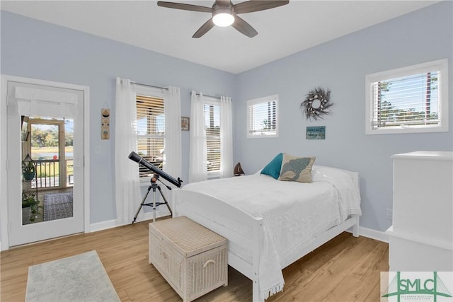 bedroom featuring ceiling fan, light hardwood / wood-style floors, and access to exterior