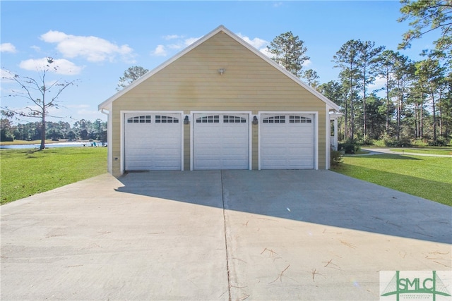 garage with a lawn and a water view