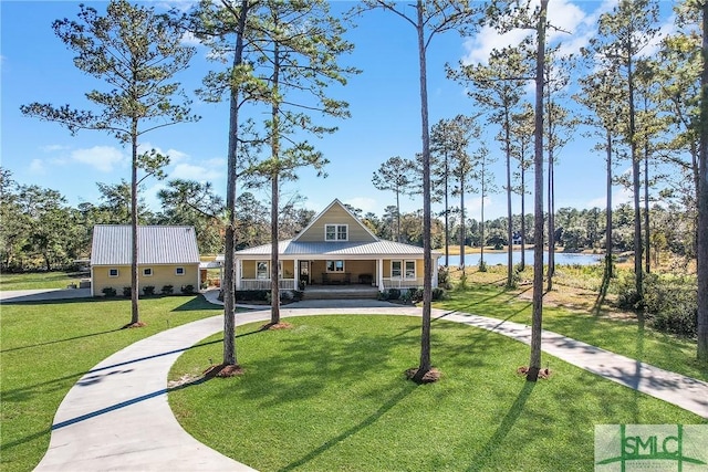 view of property's community with a water view and a yard