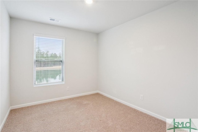 unfurnished room featuring light colored carpet