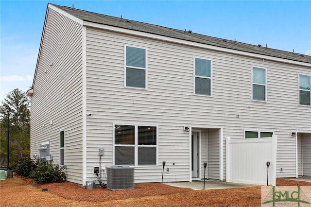 rear view of property featuring a patio and cooling unit