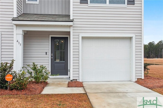 view of exterior entry with a garage