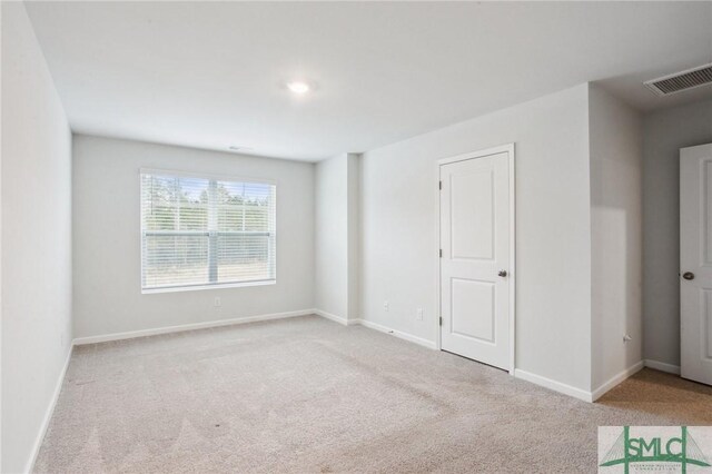 empty room featuring light colored carpet