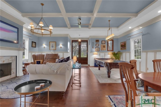 living room featuring a fireplace, coffered ceiling, french doors, beam ceiling, and dark wood-type flooring