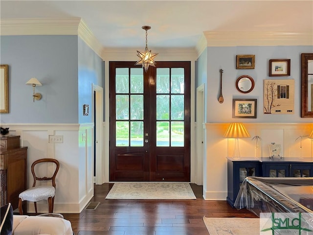 doorway with dark wood-type flooring, crown molding, french doors, and a healthy amount of sunlight