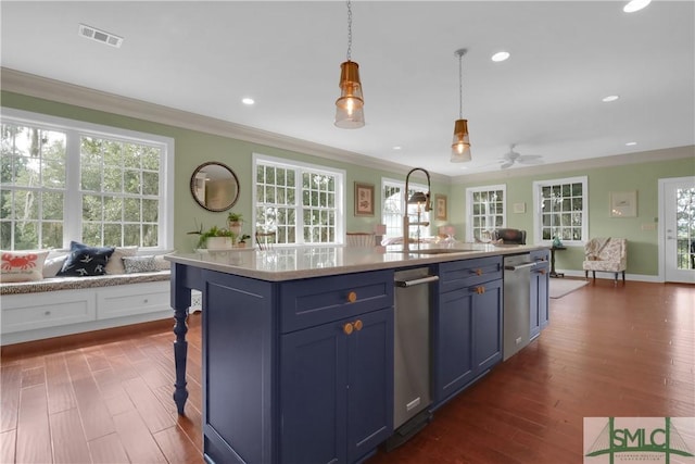 kitchen featuring pendant lighting, dark hardwood / wood-style flooring, blue cabinets, ornamental molding, and a kitchen island