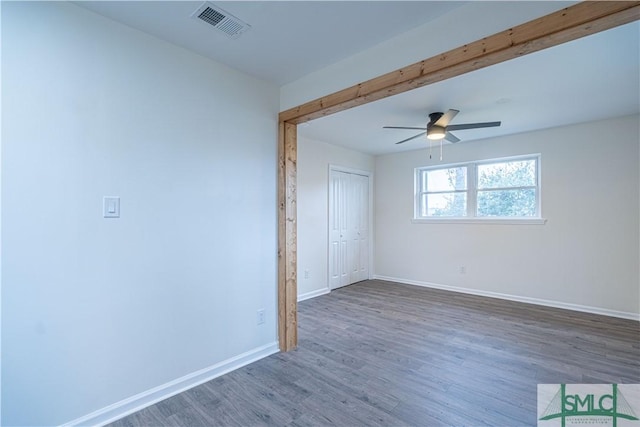 unfurnished room featuring ceiling fan and dark hardwood / wood-style floors