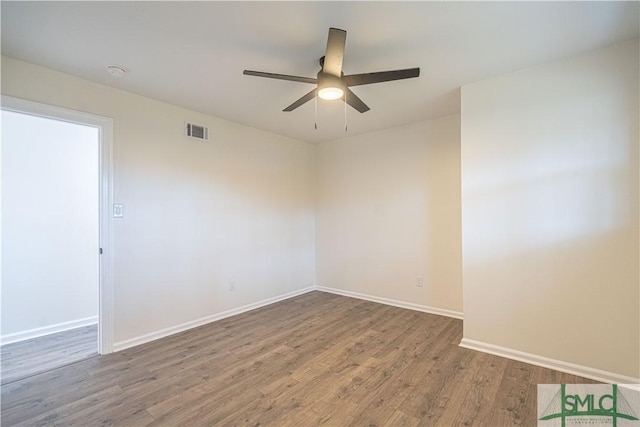 empty room with ceiling fan and wood-type flooring