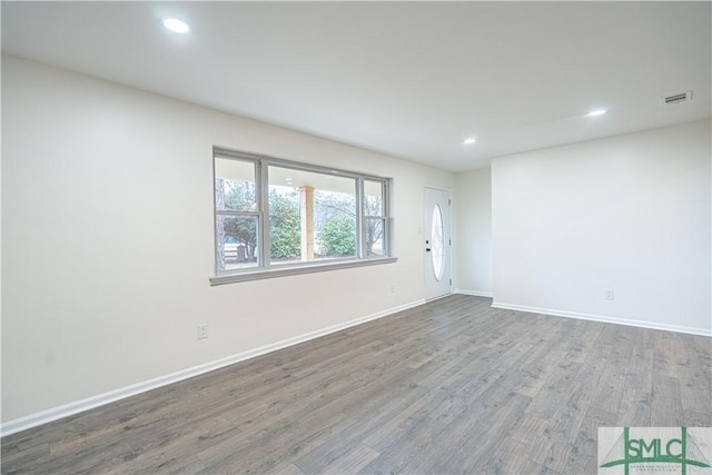 spare room with hardwood / wood-style floors