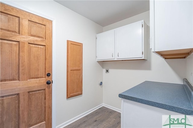 laundry area featuring dark wood-type flooring, cabinets, and hookup for an electric dryer