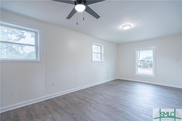 unfurnished room with ceiling fan, crown molding, and dark hardwood / wood-style floors