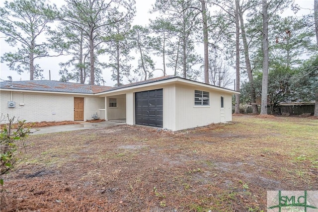 exterior space with a lawn and a garage