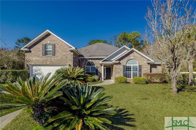 view of front of home with a front lawn and a garage