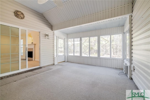 unfurnished sunroom featuring lofted ceiling and ceiling fan