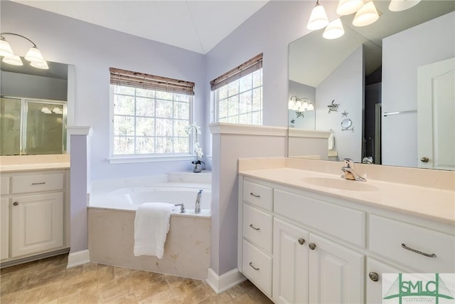 bathroom featuring vaulted ceiling, vanity, and shower with separate bathtub