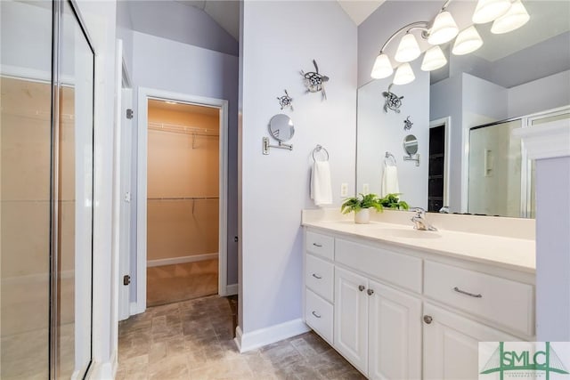 bathroom featuring vanity and a shower with shower door