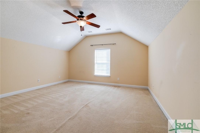 bonus room with ceiling fan, light carpet, lofted ceiling, and a textured ceiling