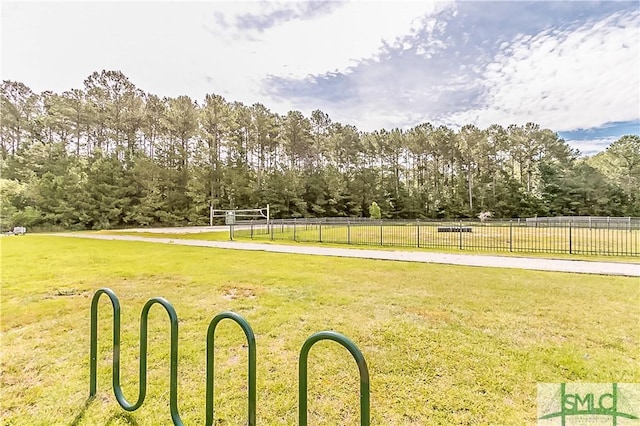 view of community with volleyball court and a yard