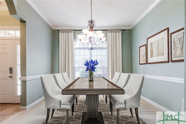 dining area with ornamental molding and a chandelier