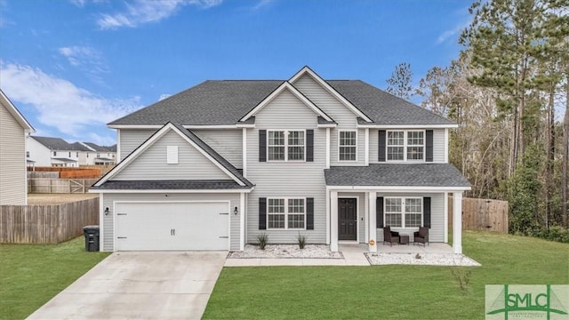 view of front of house with a porch, a front lawn, and a garage