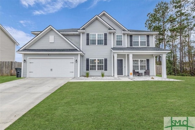 view of front of home with a front yard, a garage, and covered porch