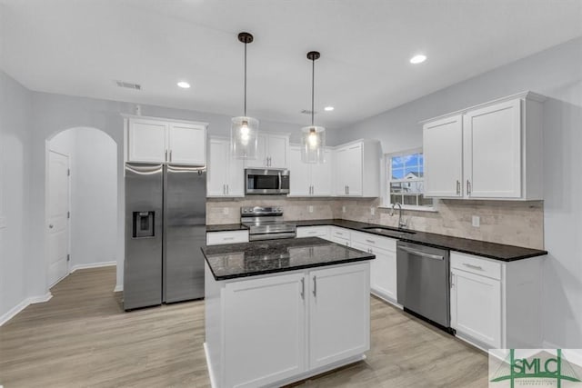 kitchen featuring sink, a kitchen island, white cabinets, and appliances with stainless steel finishes