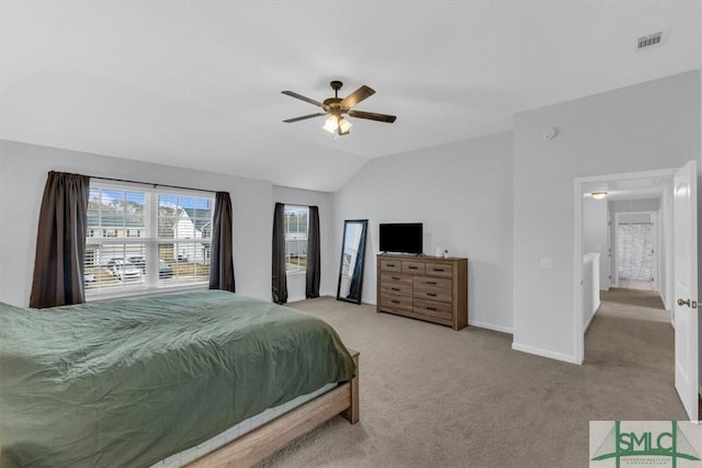 carpeted bedroom featuring ceiling fan and vaulted ceiling