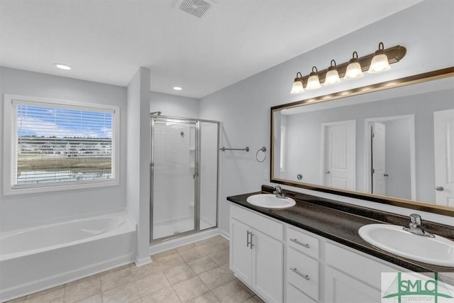 bathroom with independent shower and bath and vanity