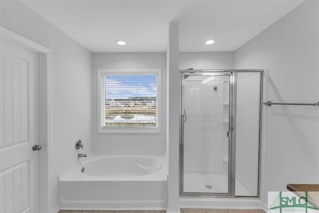 bathroom featuring plus walk in shower and vanity