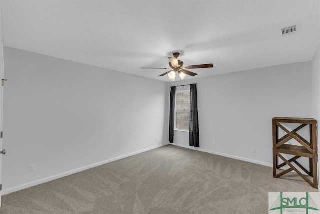 carpeted spare room with ceiling fan